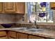 Close-up of stainless steel sink with granite countertop and view of floral arrangement at 12228 Kirby Smith Rd, Orlando, FL 32832