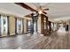 Spacious living area showcasing tile floors, a spiral staircase, and wood beam features at 12228 Kirby Smith Rd, Orlando, FL 32832