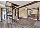 Open living area with unique spiral staircase, tile floors, and wood beam features at 12228 Kirby Smith Rd, Orlando, FL 32832