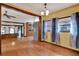 Open-concept room with hardwood floors, adjacent to kitchen, featuring staircase and natural lighting at 12228 Kirby Smith Rd, Orlando, FL 32832