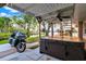 Outdoor space featuring a spa and motorcycle, with view of waterfront at 12228 Kirby Smith Rd, Orlando, FL 32832