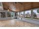 Bright sunroom with tiled floors, tongue and groove ceiling, and large windows overlooking lush landscaping at 12228 Kirby Smith Rd, Orlando, FL 32832