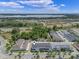 Aerial perspective of blue townhomes in a community near major roadways and a scenic lake at 1324 Painted Bunting Ave, Oakland, FL 34787