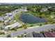 Aerial view of the community featuring a pool, lake, walking path, and well-maintained lawns and landscaping at 1324 Painted Bunting Ave, Oakland, FL 34787