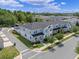 Aerial view of blue townhomes, showcasing the community layout, sidewalks, and parking areas at 1324 Painted Bunting Ave, Oakland, FL 34787