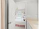 Bright bathroom with view to bedroom featuring two twin beds with white bedding at 1324 Painted Bunting Ave, Oakland, FL 34787