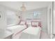 Charming bedroom with two twin beds, bright windows and attractive chandelier at 1324 Painted Bunting Ave, Oakland, FL 34787