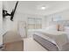 Bright bedroom with a tufted bed, large mirror, and window views at 1324 Painted Bunting Ave, Oakland, FL 34787