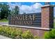 Attractive Longleaf at Oakland community sign features brick and stone accents, enhanced by lush landscaping at 1324 Painted Bunting Ave, Oakland, FL 34787