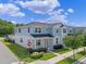 Charming two-story townhome with a light blue exterior, well-manicured lawn, and a welcoming front porch at 1324 Painted Bunting Ave, Oakland, FL 34787