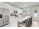 Modern white kitchen with stainless steel appliances and large center island with bar seating at 1324 Painted Bunting Ave, Oakland, FL 34787