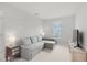 Cozy living room with a comfortable couch, TV, and natural light from the window at 1324 Painted Bunting Ave, Oakland, FL 34787