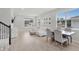 Open concept living and dining area featuring stylish decor, natural light, and wood flooring at 1324 Painted Bunting Ave, Oakland, FL 34787