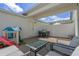 Cozy patio with playhouse, covered area, privacy fence, and comfortable seating - great for entertaining at 1324 Painted Bunting Ave, Oakland, FL 34787