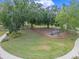 Aerial view of community playground with lush green surroundings and modern play equipment, perfect for outdoor fun at 1324 Painted Bunting Ave, Oakland, FL 34787