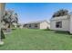 Spacious backyard showcasing the property's well-maintained lawn and several home exteriors at 1461 Sothell St, The Villages, FL 32162