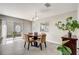 Dining room with sliding doors to lanai and view of backyard at 1461 Sothell St, The Villages, FL 32162