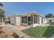 Exterior view of home with screen enclosed lanai and vinyl siding at 1461 Sothell St, The Villages, FL 32162