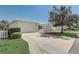 Well-maintained single-story home with a concrete driveway, attached garage, and manicured lawn at 1461 Sothell St, The Villages, FL 32162