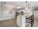 Open kitchen featuring white cabinets, breakfast bar, and stainless steel appliances at 1461 Sothell St, The Villages, FL 32162