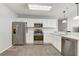 Bright kitchen features white cabinets, stainless steel appliances, and modern countertops at 1461 Sothell St, The Villages, FL 32162