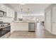 Open kitchen with stainless steel appliances flows into the living and dining areas at 1461 Sothell St, The Villages, FL 32162