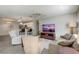 Open concept living area featuring a ceiling fan and view of the kitchen at 1461 Sothell St, The Villages, FL 32162