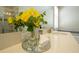 Bright bathroom with a large mirror, decorative flowers, and a clean, modern countertop at 1577 Mulligan Blvd, Davenport, FL 33896