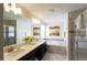 Bright bathroom featuring double sinks, soaking tub, and glass-enclosed shower at 1577 Mulligan Blvd, Davenport, FL 33896