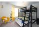 bedroom with a bunk bed and minion themed decor, creating a playful and inviting space at 1577 Mulligan Blvd, Davenport, FL 33896
