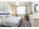 Well-lit bedroom with soft blue bedding, accent furnishings and a mirror providing space and style at 1577 Mulligan Blvd, Davenport, FL 33896