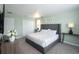 Bright, comfortable bedroom with a tufted headboard, soft green walls and modern design at 1577 Mulligan Blvd, Davenport, FL 33896
