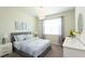 Well-lit bedroom with soft blue bedding, accent furnishings and a mirror providing space and style at 1577 Mulligan Blvd, Davenport, FL 33896
