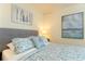 Serene bedroom showcasing a comfortable bed with patterned linens and nautical themed decor at 1577 Mulligan Blvd, Davenport, FL 33896