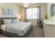Well-lit bedroom with a comfortable bed, stylish decor, and a view of a window with natural lighting at 1577 Mulligan Blvd, Davenport, FL 33896