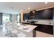 Open concept kitchen with modern appliances, breakfast bar, and an adjoining dining area at 1577 Mulligan Blvd, Davenport, FL 33896