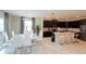 Open concept kitchen with breakfast bar and an adjoining dining area with a modern chandelier at 1577 Mulligan Blvd, Davenport, FL 33896