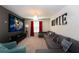 Comfortable movie room with large sectional sofa, projector screen, and dim lighting at 1577 Mulligan Blvd, Davenport, FL 33896