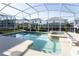 Sparkling pool and spa in a screened-in enclosure with lush landscaping at 1577 Mulligan Blvd, Davenport, FL 33896