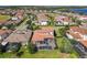 An aerial view of a property with a screened-in pool surrounded by green landscaping in a residential neighborhood at 16675 Otterchase Ln, Winter Garden, FL 34787
