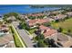 Stunning aerial view of a lakeside home showcasing the tile roof and lush landscaping near the water at 16675 Otterchase Ln, Winter Garden, FL 34787