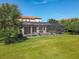 Expansive backyard featuring a screened-in pool area, with lush green grass and mature trees at 16675 Otterchase Ln, Winter Garden, FL 34787
