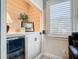 Built-in bar area with a beverage cooler, sleek countertops, and a window for natural light, perfect for entertaining guests at 16675 Otterchase Ln, Winter Garden, FL 34787