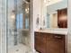 Bathroom featuring a glass walk-in shower, vanity, and rustic barn door accent in the background at 16675 Otterchase Ln, Winter Garden, FL 34787