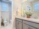 Elegant bathroom with double vanity, quartz countertops, and modern fixtures, plus a peek at the tub at 16675 Otterchase Ln, Winter Garden, FL 34787