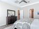 Neutral bedroom featuring dark wood floors, a dresser, tray ceiling, and entryways to other rooms at 16675 Otterchase Ln, Winter Garden, FL 34787