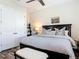 Bedroom features a dark wood frame bed with matching nightstand and neutral wall paint at 16675 Otterchase Ln, Winter Garden, FL 34787
