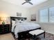 Bedroom features a dark wood frame bed with matching nightstand and modern ceiling fan at 16675 Otterchase Ln, Winter Garden, FL 34787
