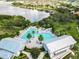 A serene aerial view of a resort-style pool and amenities nestled beside a tranquil lake community at 16675 Otterchase Ln, Winter Garden, FL 34787