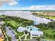 Aerial view of the community pool, clubhouse and a lake in the background on a clear, sunny day at 16675 Otterchase Ln, Winter Garden, FL 34787